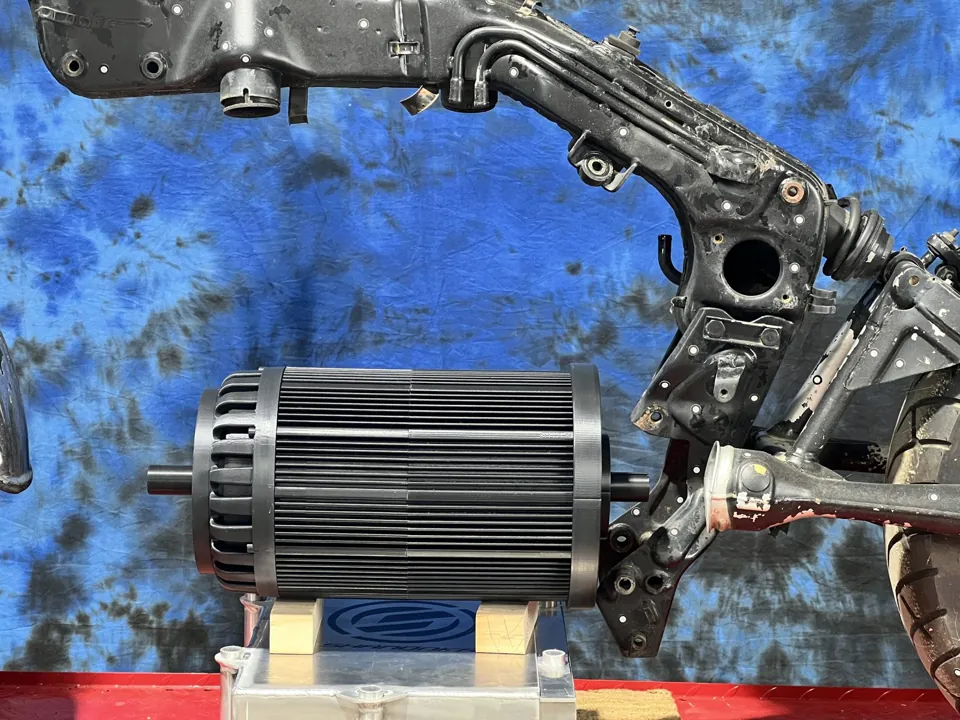An electric motor set in a motorcycle frame on the shop bench