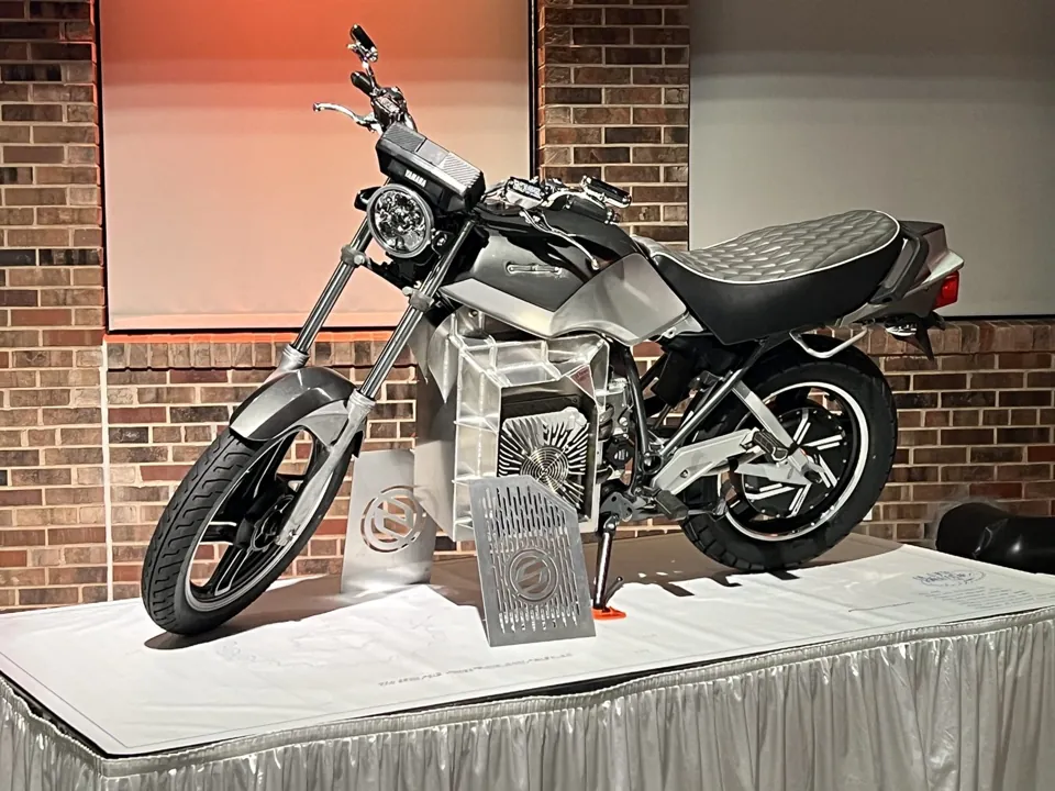 A Shandoka electric motorcycle on a display stand