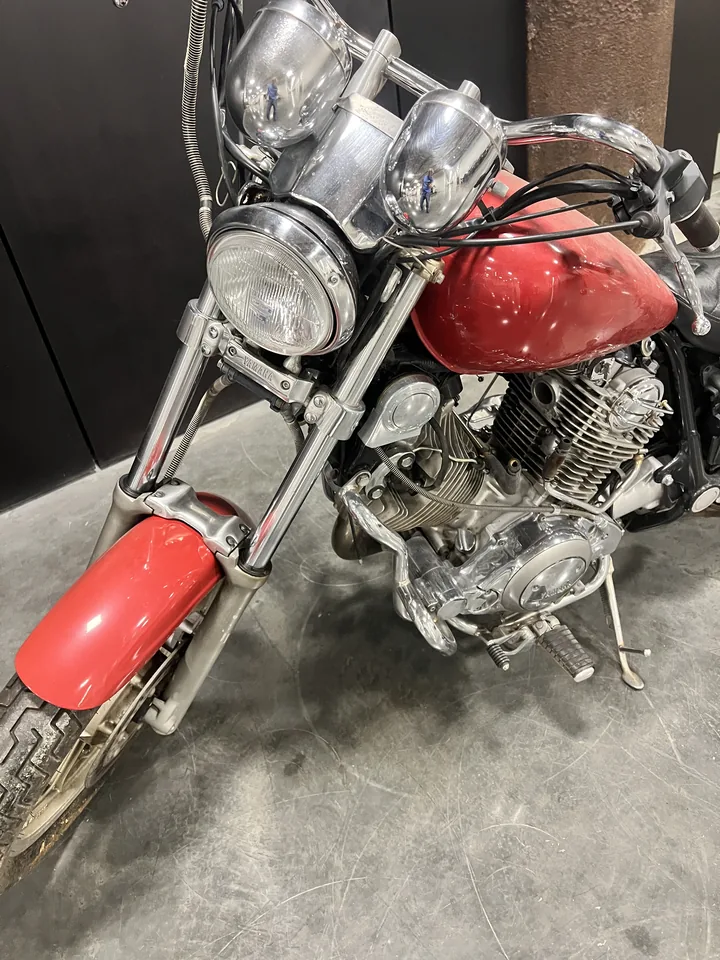 Big Red's front end: headlight, forks and the red tank seen from ahead.