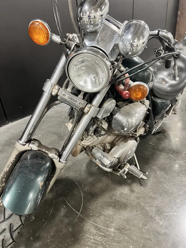 The Green Machine from ahead: headlight, forks and the engine it still carries.