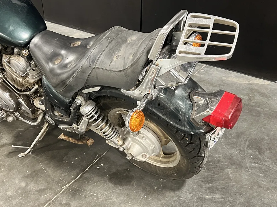 The Green Machine's rear rack, tail light and seat, with the wear of years in a garage.