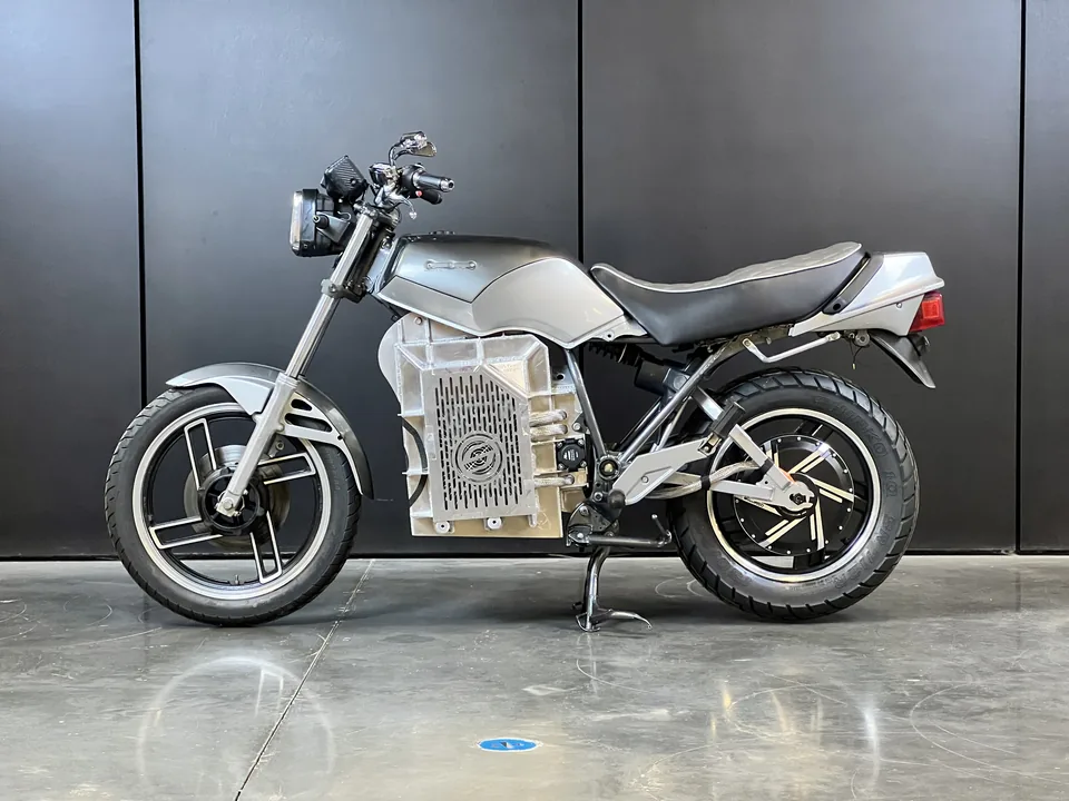 The SECA QuickSilver converted to electric, silver bodywork and the battery box where the engine sat, side on.